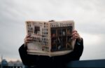 A person reading a newspaper